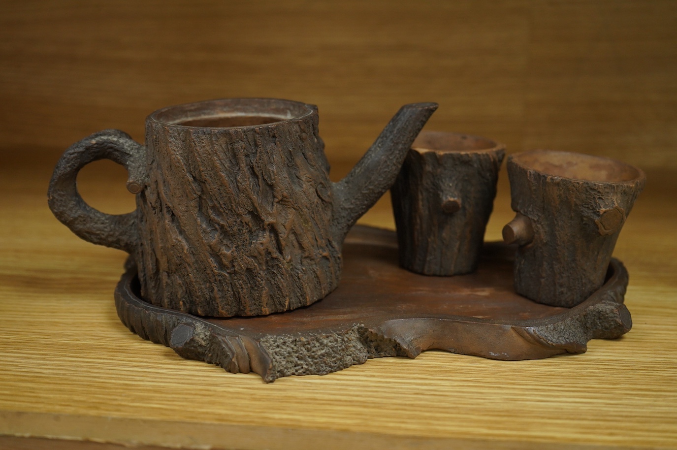 A Chinese naturalistic Yixing teapot, two cups and tray, early 20th century, 25cm high. Condition - fair/good
